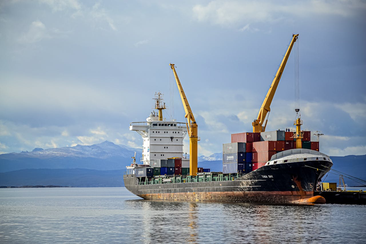 Cargo Ship on Sea Under White Clouds